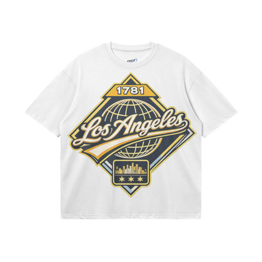 White heavyweight boxy T-shirt featuring a gold, black, and cream Los Angeles 1781 heritage graphic with globe and skyline artwork.