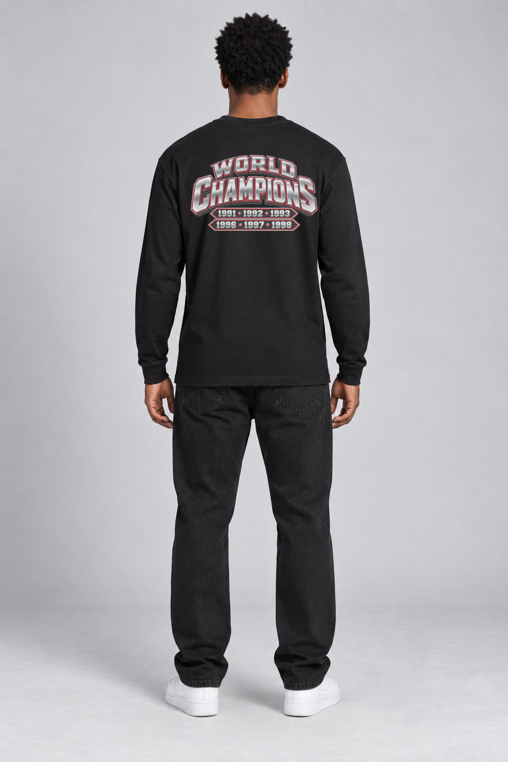 Chicago 6-Time City Champions black 220 GSM long-sleeve T-shirt on male model – full-body back view with small centered championship artwork | City 2 City Wear