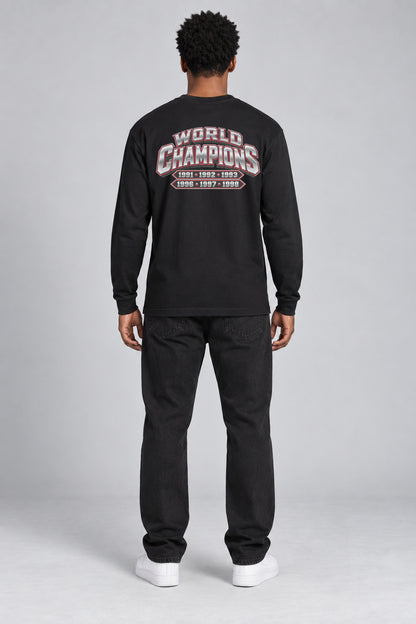 Chicago 6-Time City Champions black 220 GSM long-sleeve T-shirt on male model – full-body back view with small centered championship artwork | City 2 City Wear