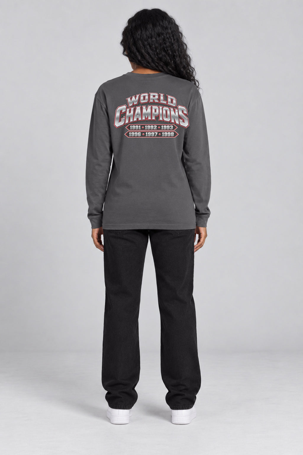 Chicago 6-Time City Champions dark gray 220 GSM long-sleeve T-shirt on female model – full-body back view with small centered championship artwork | City 2 City Wear