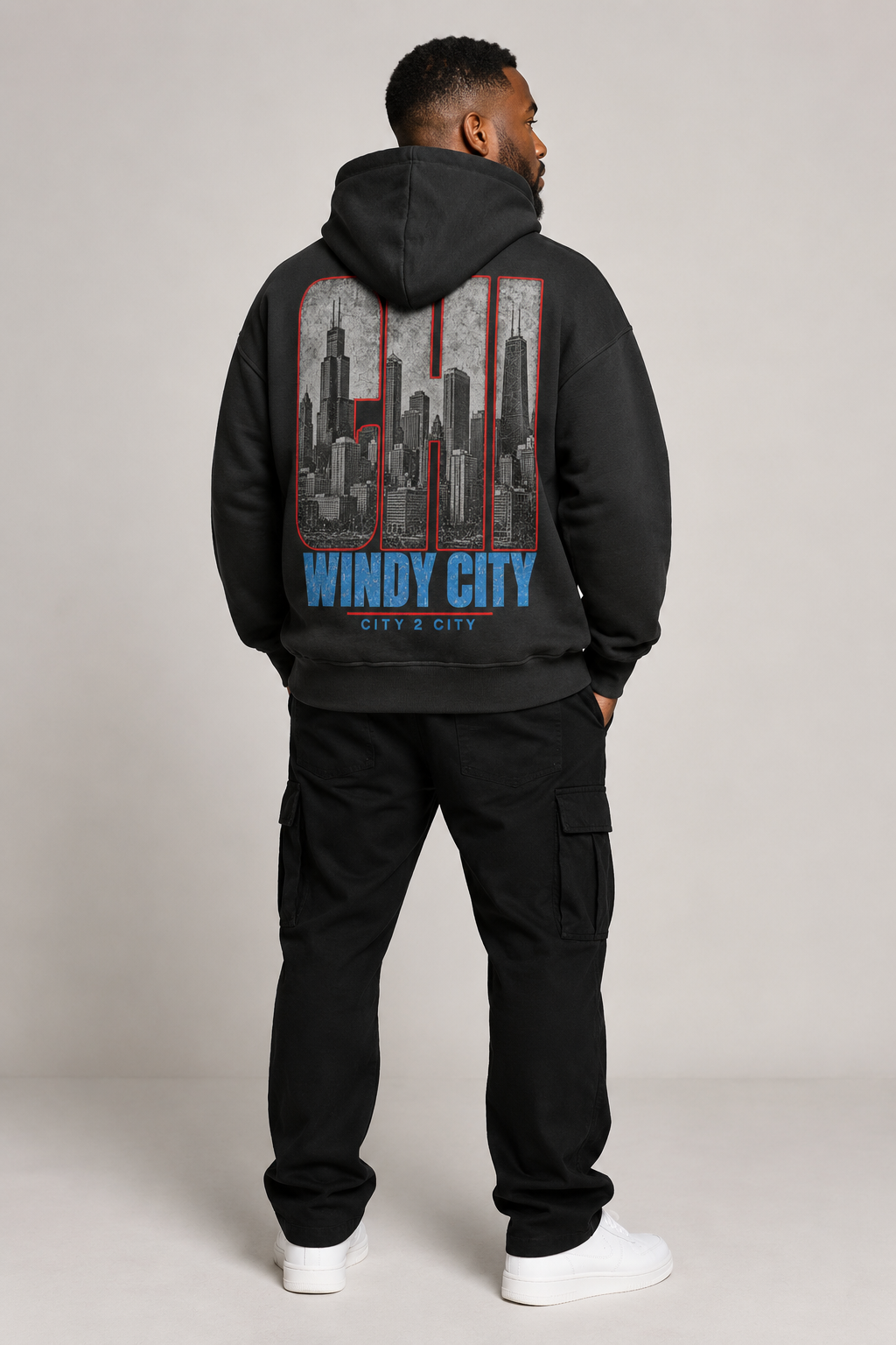 Chicago Windy City Skyline 440 GSM Oversized Hoodie, Faded Black back-view full-body men’s studio model photo, Chicago | City 2 City Wear