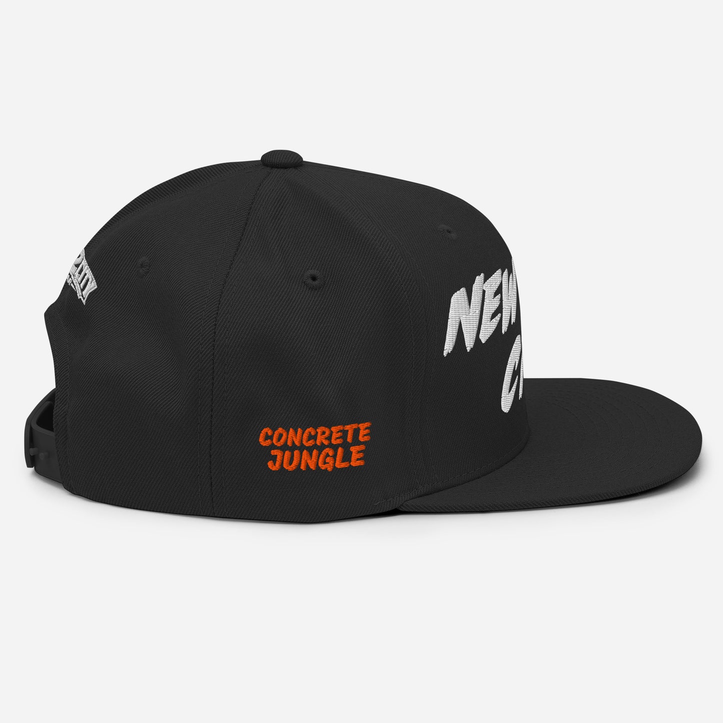Side view of a black New York City snapback featuring orange embroidered CONCRETE JUNGLE lettering.