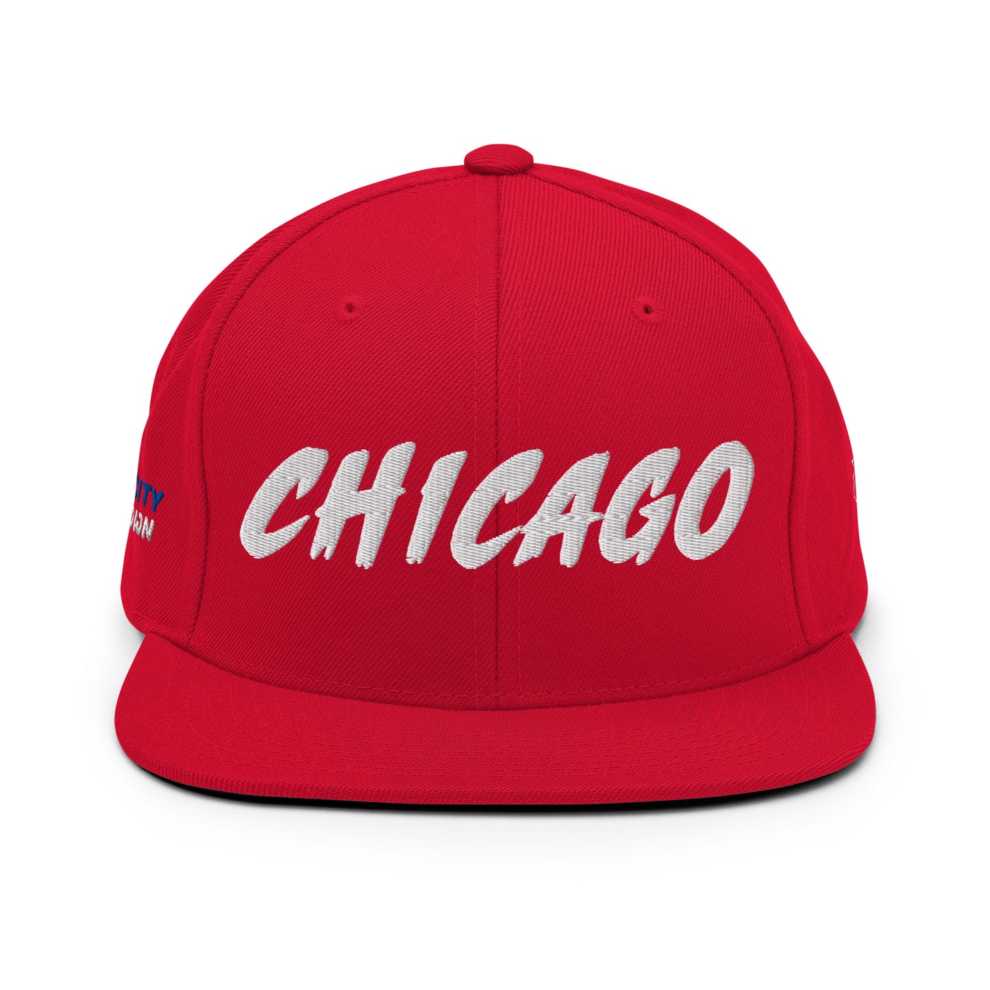 Front view of a red snapback hat with large white embroidered CHICAGO lettering.