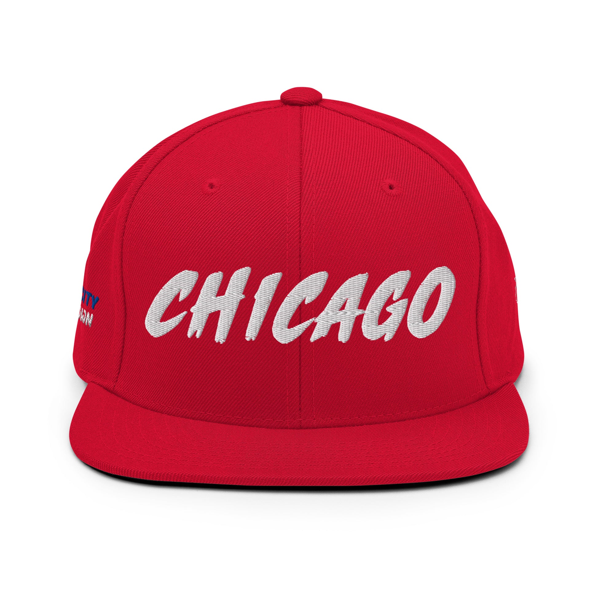 Front view of a red snapback hat with large white embroidered CHICAGO lettering.