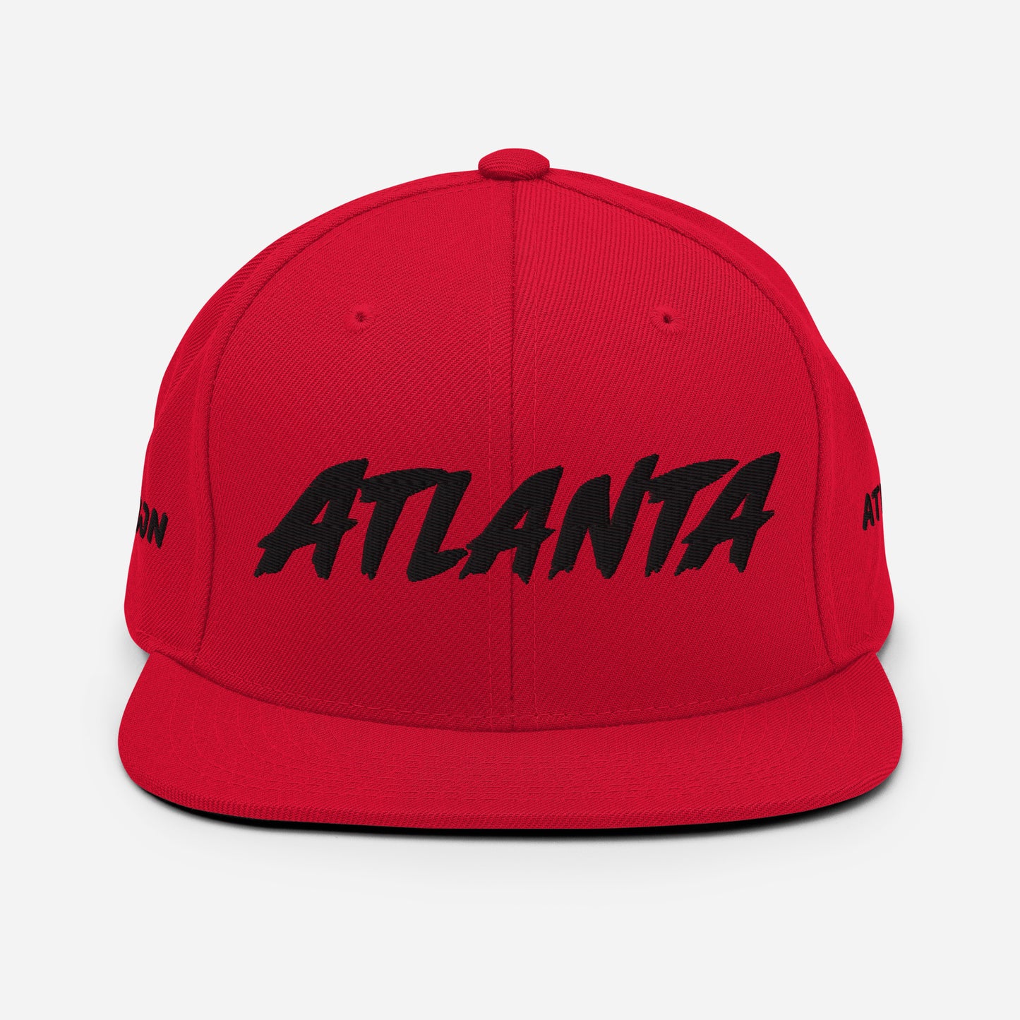 Front view of a red snapback hat featuring large black embroidered ATLANTA lettering.