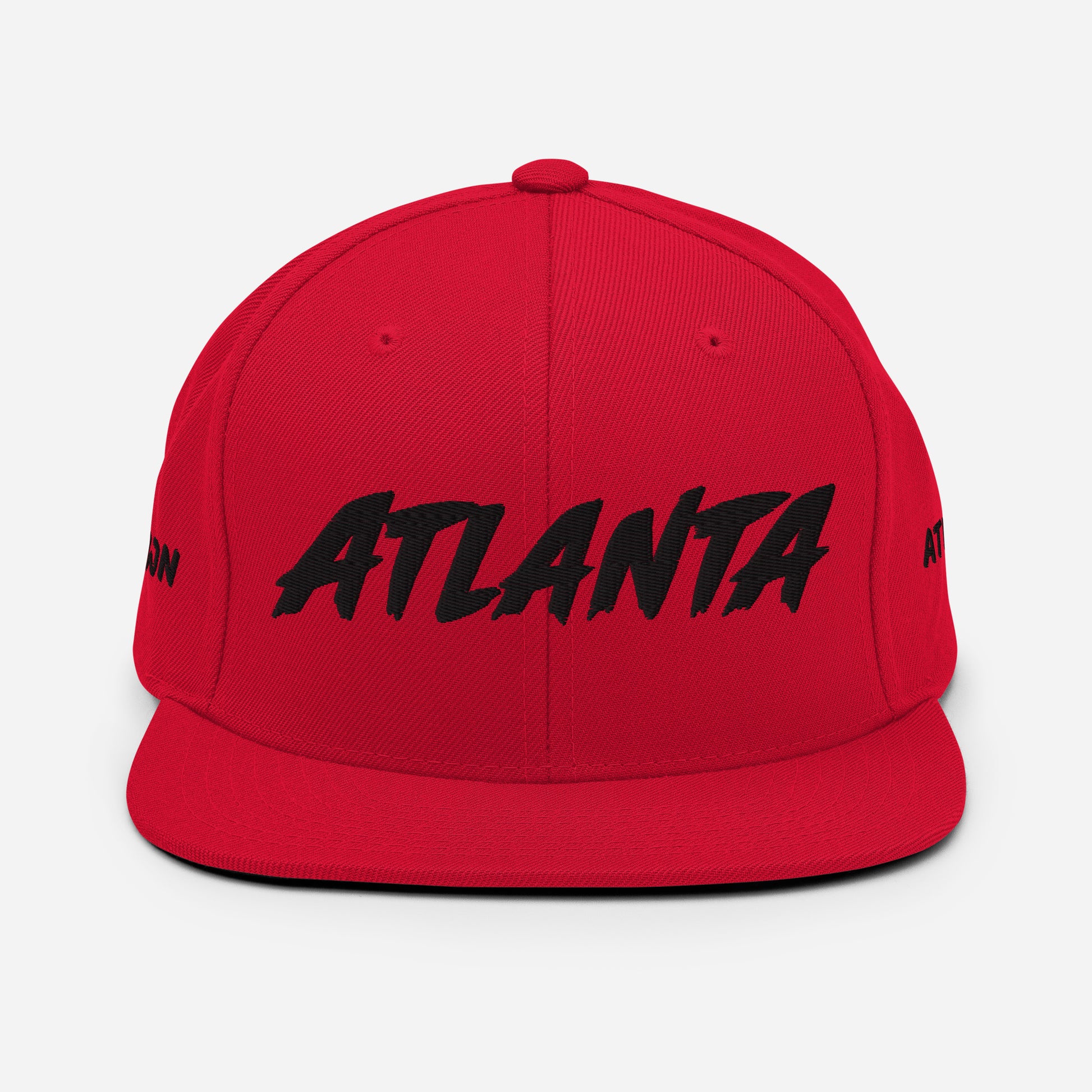 Front view of a red snapback hat featuring large black embroidered ATLANTA lettering.