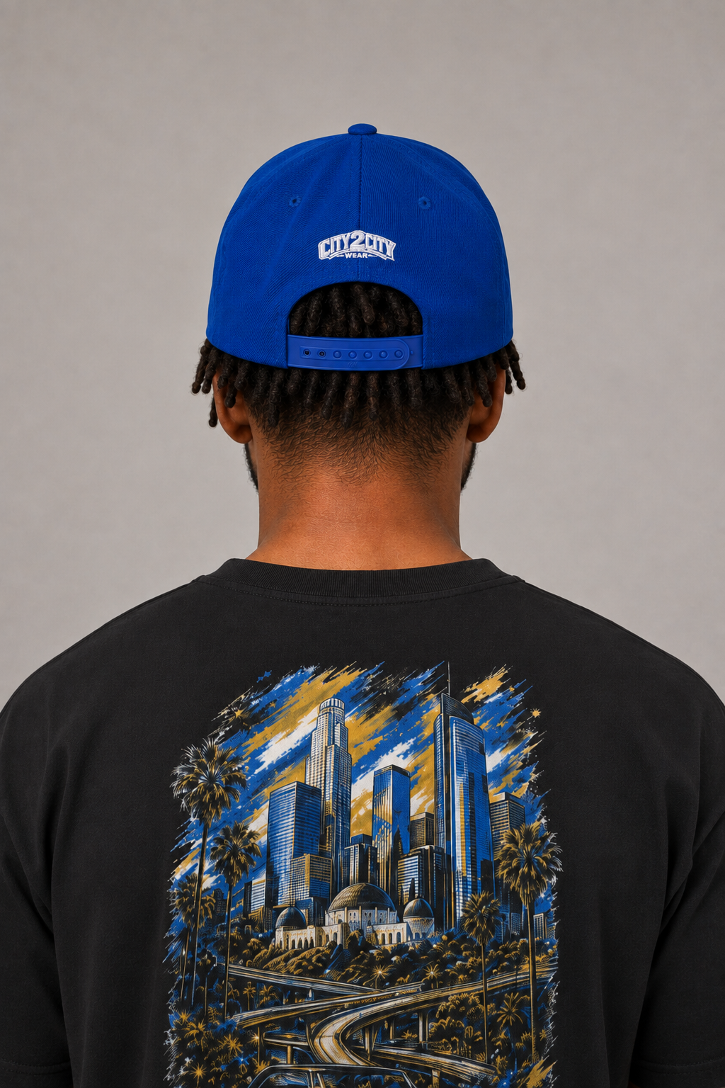 Los Angeles City of Angels Royal Blue Embroidered Snapback Hat — rear model close-up showing white City 2 City Wear logo and adjustable royal blue snap closure | City 2 City Wear