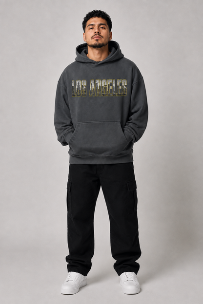 Los Angeles City of Angels Skyline 440 GSM Oversized Hoodie, Carbon Gray front-view full-body men’s studio model photo, Los Angeles | City 2 City Wear