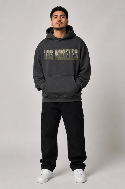 Los Angeles City of Angels Skyline 440 GSM Oversized Hoodie, Faded Black front-view full-body men’s studio model photo, Los Angeles | City 2 City Wear