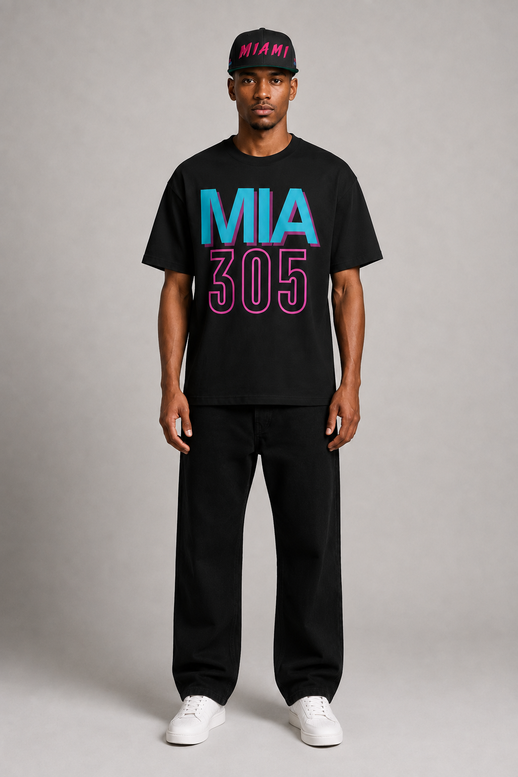 Miami 305 Till I Die Black Embroidered Snapback Hat — full-body Miami streetwear model wearing hot-pink MIAMI snapback and black teal-and-pink Miami 305 Skyline T-shirt | City 2 City Wear