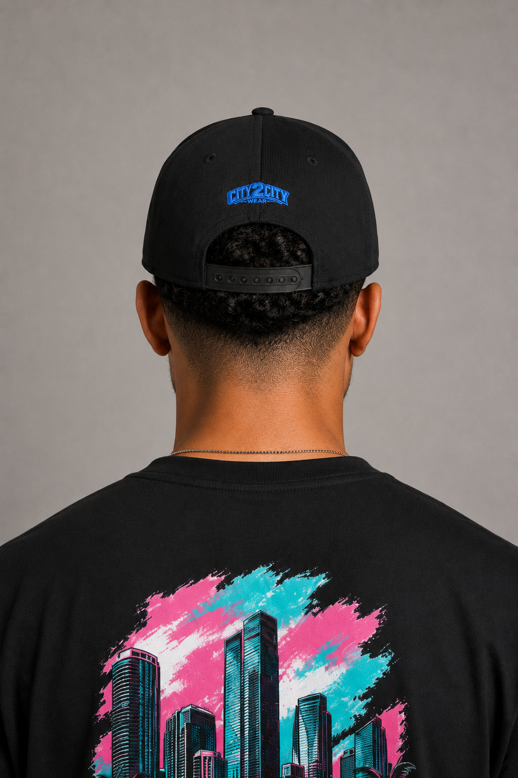 Miami 305 Till I Die Black Embroidered Snapback Hat — rear Miami model close-up showing electric-blue City 2 City Wear embroidery, black adjustable snap closure, and Miami skyline T-shirt | City 2 City Wear