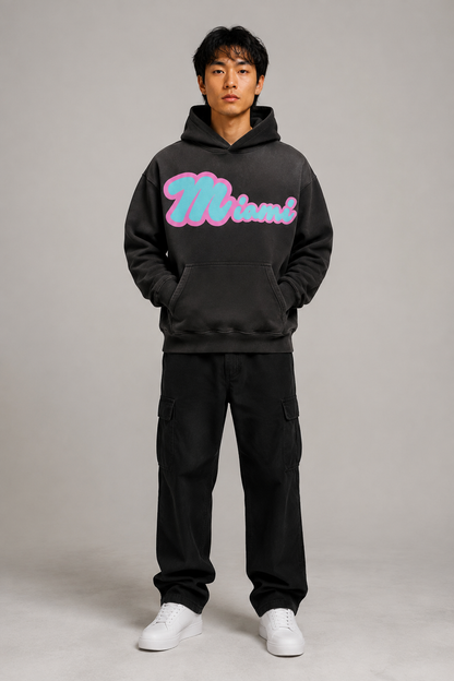 Miami Script Teal & Pink 440 GSM Heavyweight Washed Oversized Hoodie, Faded Black front-view full-body men’s studio model photo, Miami | City 2 City Wear