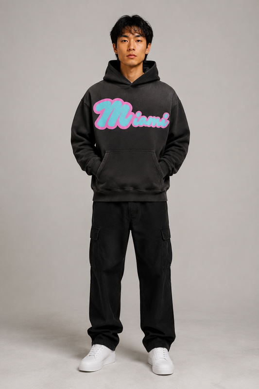 Miami Script Teal & Pink 440 GSM Heavyweight Washed Oversized Hoodie, Faded Black front-view full-body men’s studio model photo, Miami | City 2 City Wear