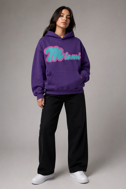 Miami Script Teal & Pink 440 GSM Heavyweight Washed Oversized Hoodie, Purple Haze three-quarter front full-body women’s studio model photo, Miami | City 2 City Wear