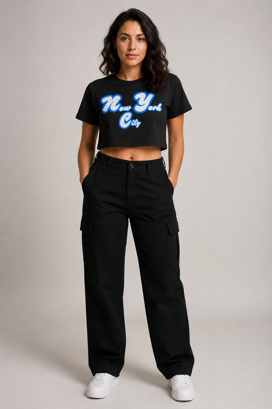 New York City Script Women’s Crop T-Shirt in Black, full-body studio model wearing royal-blue and white NYC graphic crop top | City 2 City Wear