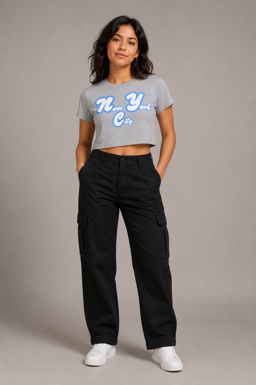 New York City Script Women’s Crop T-Shirt in Light Gray, full-body studio model wearing royal-blue and white NYC graphic crop top | City 2 City Wear