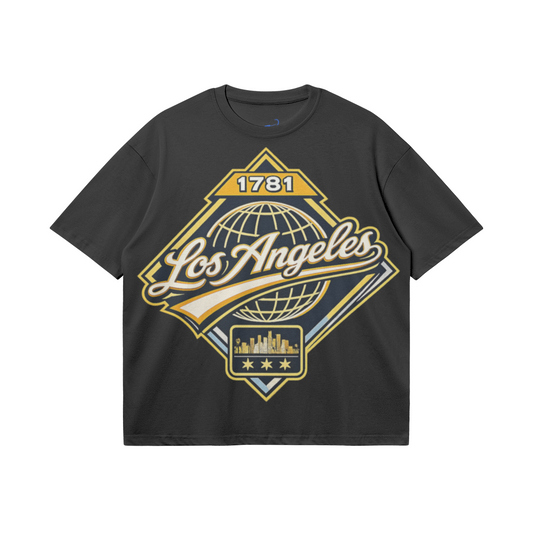 Black heavyweight boxy T-shirt featuring a gold, cream, and light-blue Los Angeles 1781 heritage graphic with globe and skyline artwork